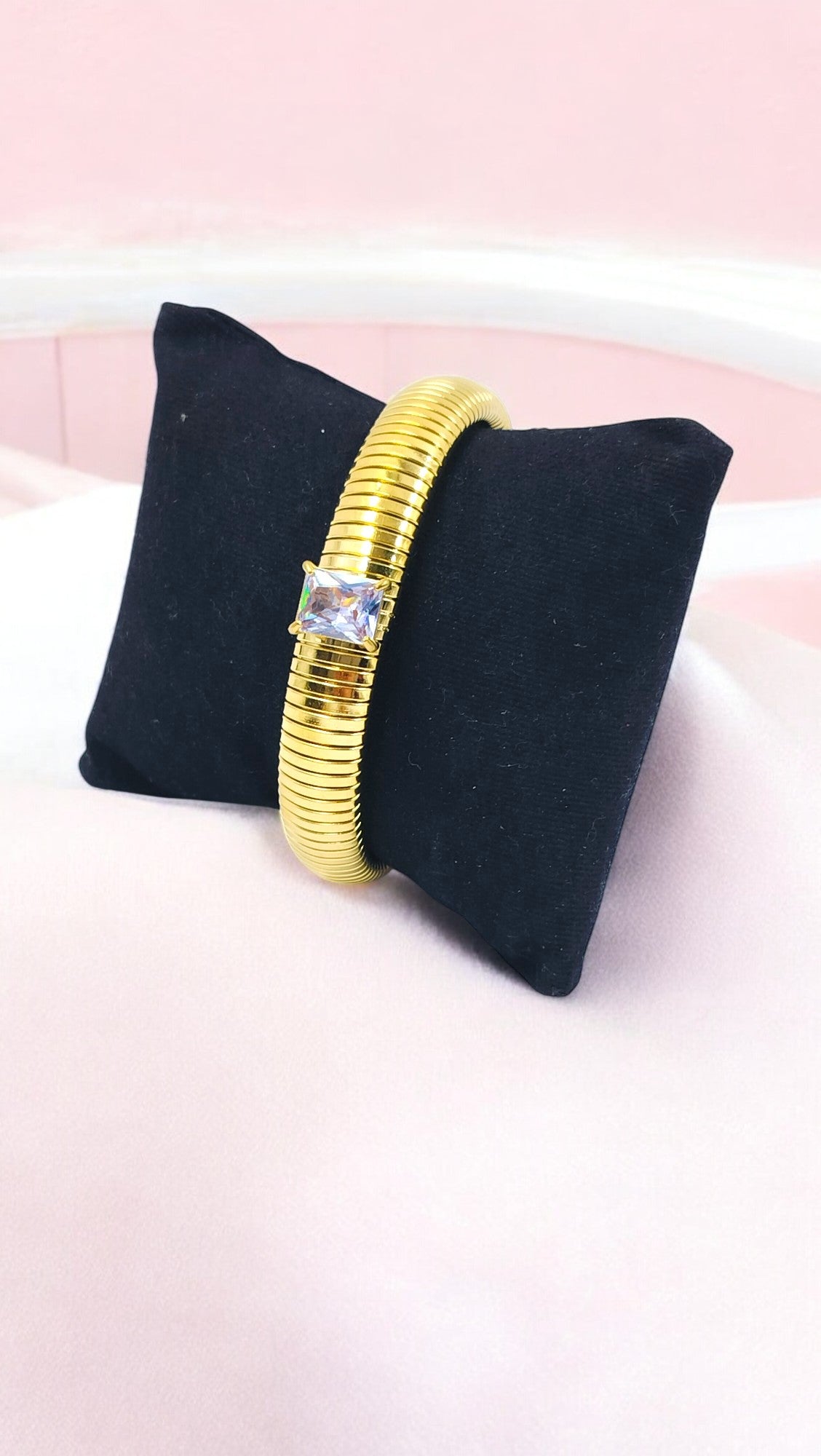 Stylish gold plated bangle with a sparkling solitaire centerpiece, perfect for adding elegance to both daily wear and party looks.