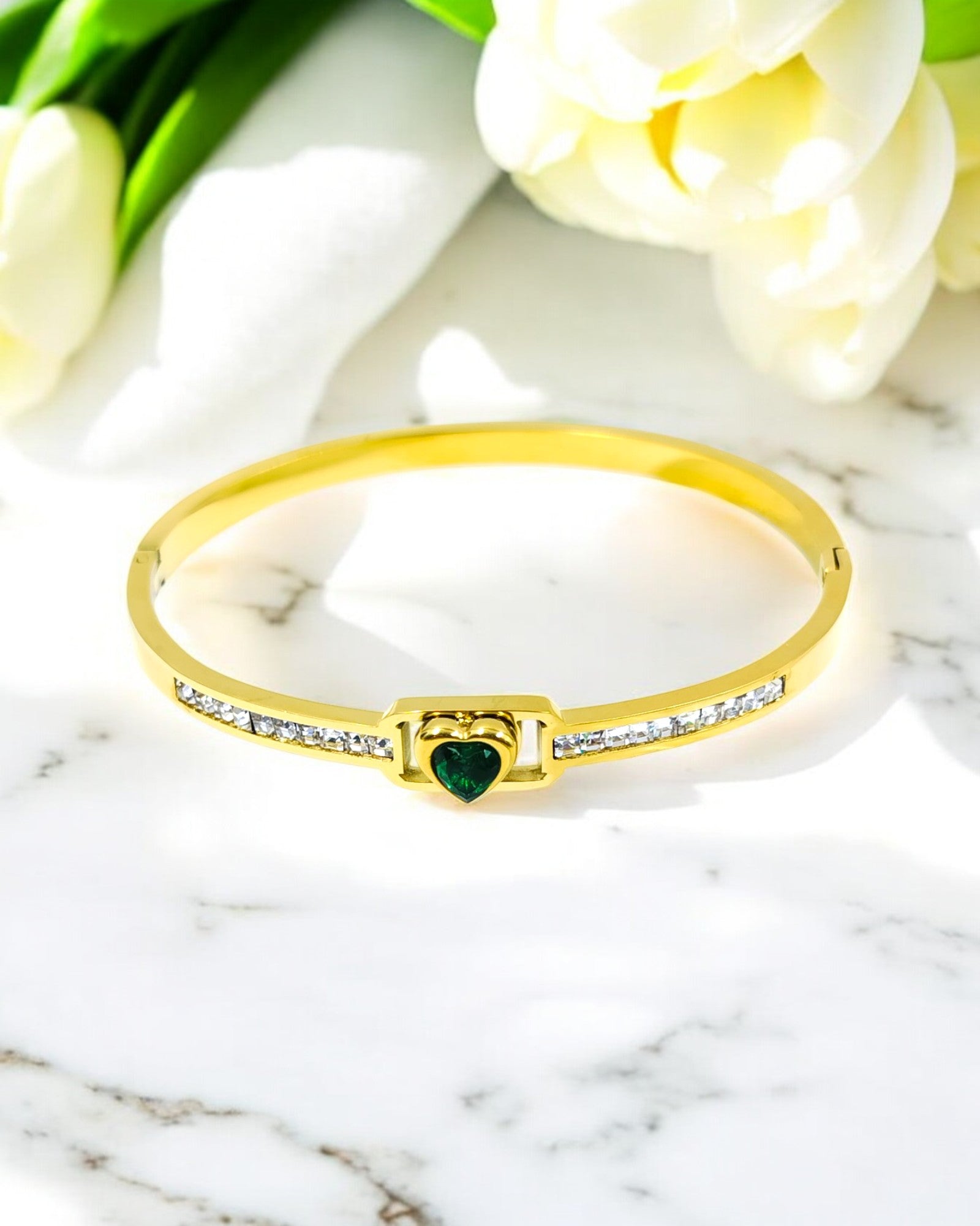 Stylish gold plated bracelet featuring a green heart centerpiece with sparkling CZ stones, a perfect blend of elegance for daily wear and special occasions.