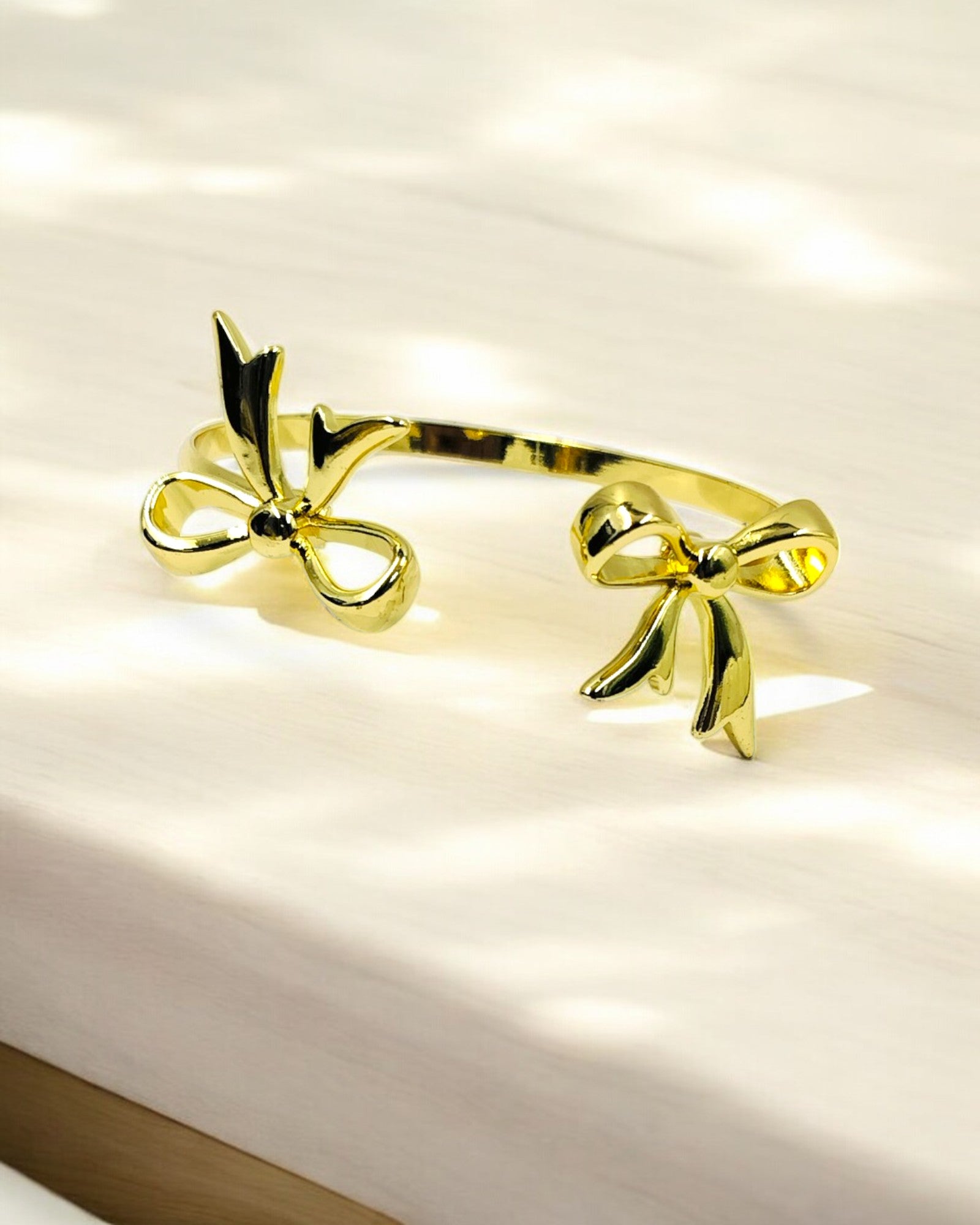 Stylish gold plated open bracelet with dual bow design, trendy women’s jewelry perfect for parties, gifting and daily wear.