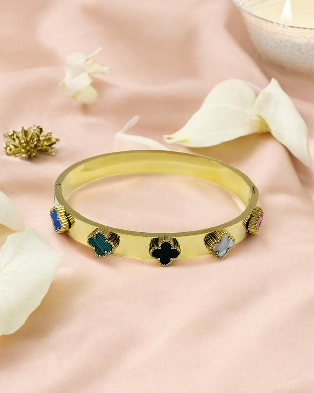 Trendy gold plated bangle bracelet with multicolor clover charms, stylish fashion jewelry perfect for parties and gifting.