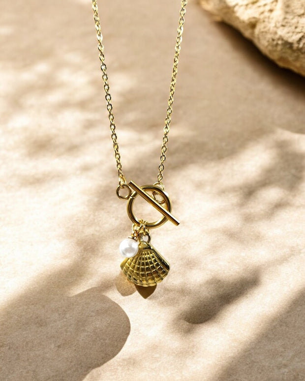 Elegant gold plated seashell pendant necklace with pearl charm, stylish beach inspired jewelry for women’s casual fashion.