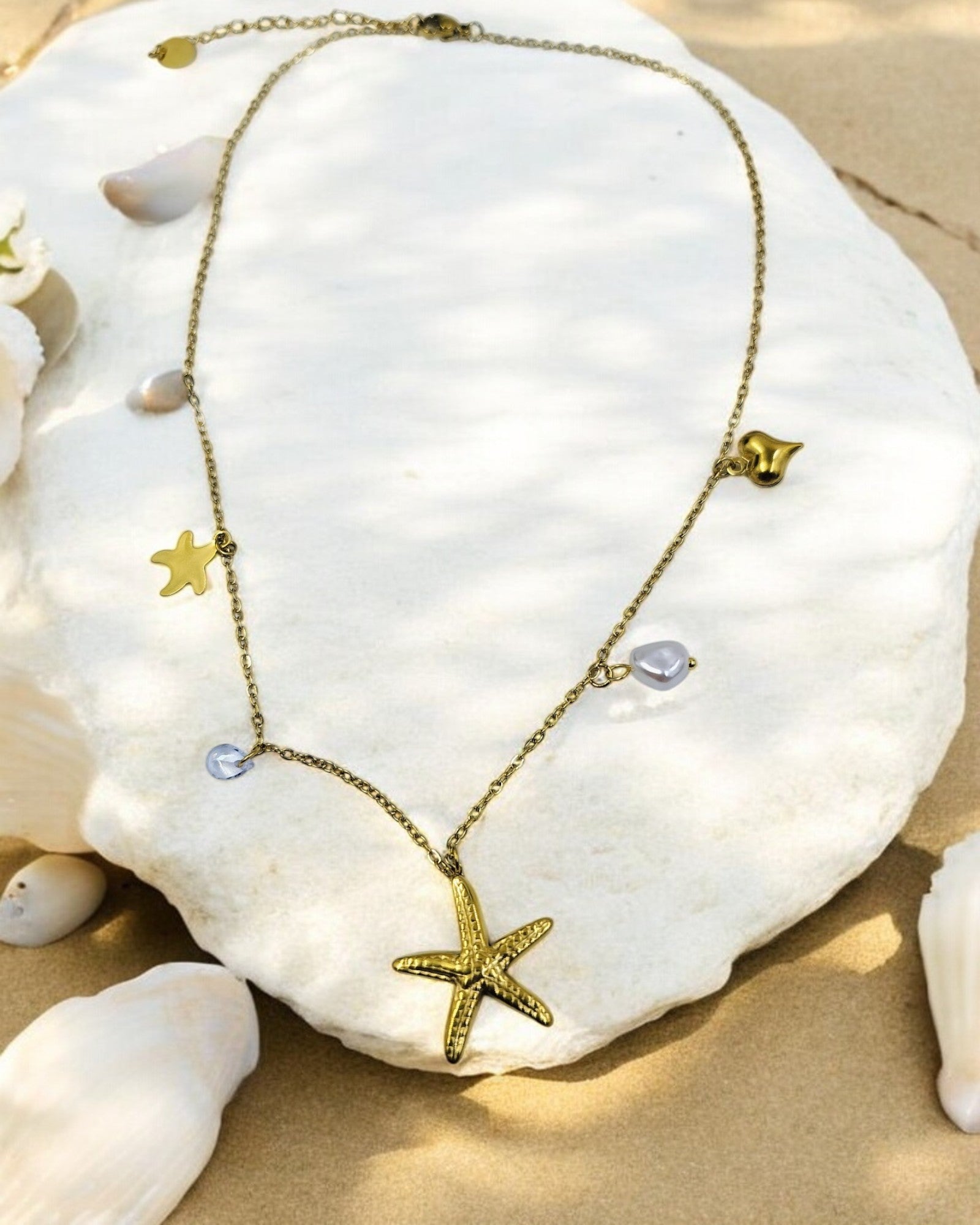 Trendy gold plated starfish pendant necklace with charms, stylish beach jewelry perfect for vacations and summer outfits.