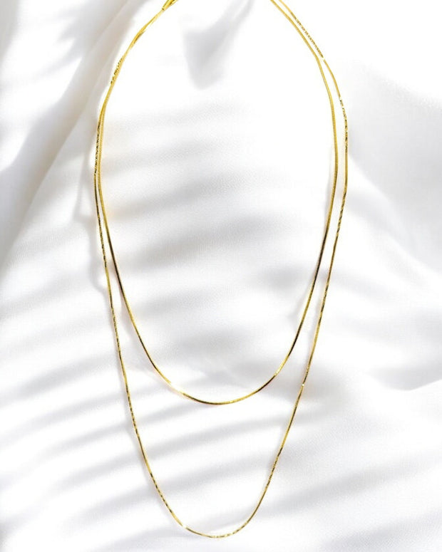 Minimalist gold plated layered chain necklace for women, elegant lightweight jewelry for modern everyday style.