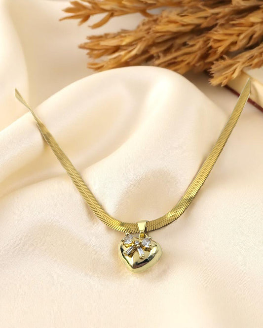 Gold plated necklace with heart shaped crystal pendant on satin fabric – Glampouch jewelry