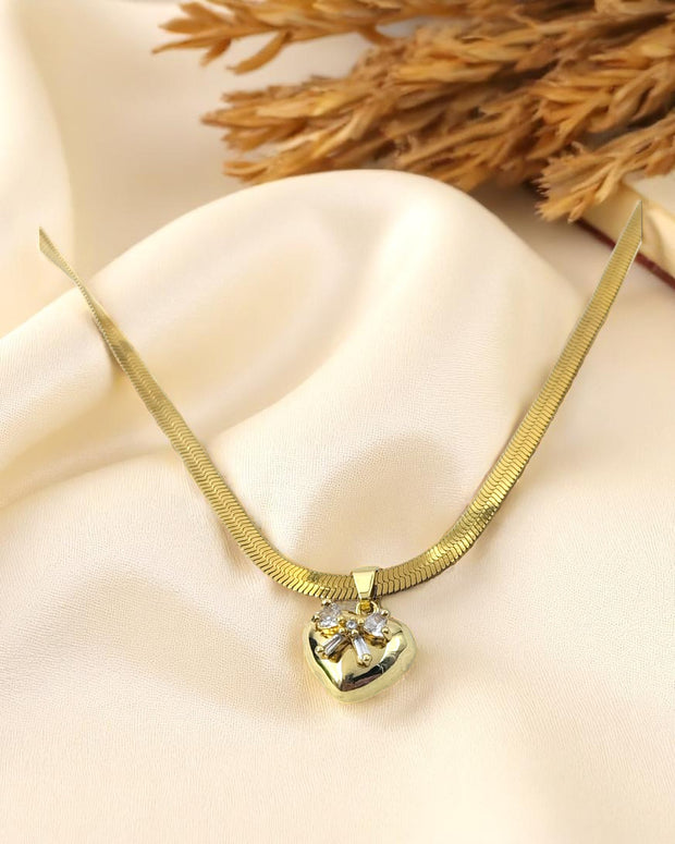 Gold plated necklace with heart shaped crystal pendant on satin fabric – Glampouch jewelry