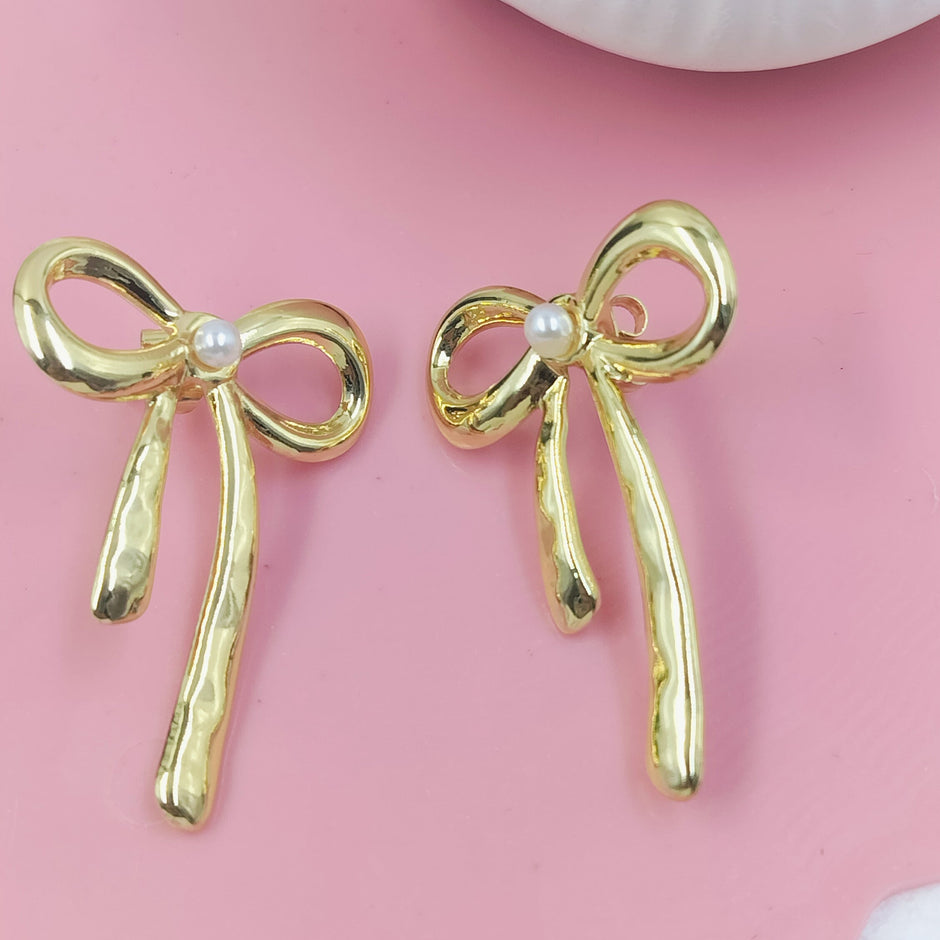 Chic gold bow stud earrings with pearl accents, feminine and stylish design perfect for everyday wear or gifting.