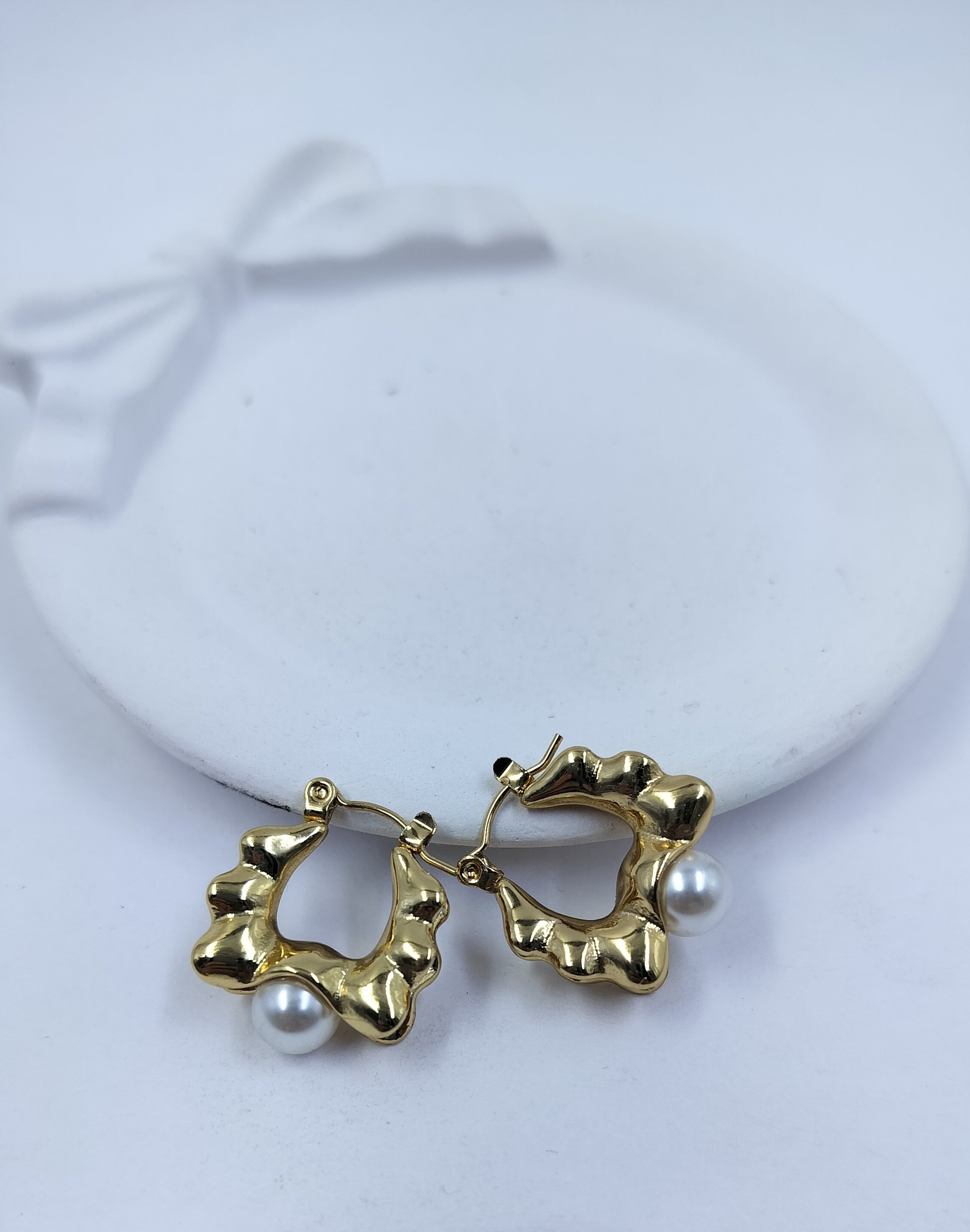 Elegant gold textured hoop earrings with pearl drop, lightweight anti-tarnish jewelry for women ideal for party and festive wear.