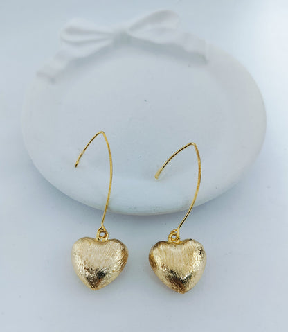 Elegant gold heart shaped dangle earrings with textured finish, perfect for women’s fashion jewelry and gifting
