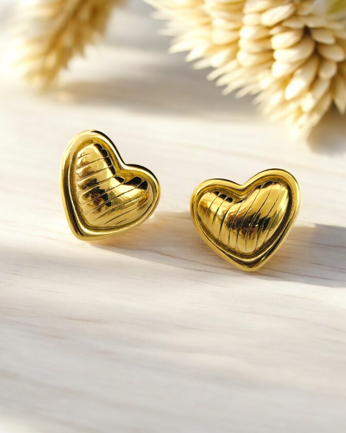 Gold heart stud earrings with textured design, elegant and romantic jewelry for women