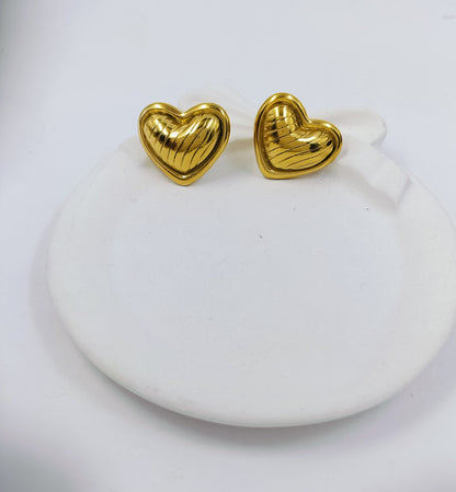 Elegant gold heart stud earrings with textured shine, minimal and romantic jewelry for women