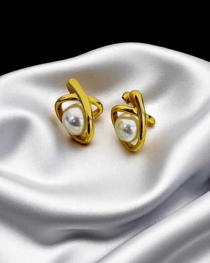 Elegant gold-plated stud earrings with pearl center, showcased on luxurious white satin – Glampouch jewelry