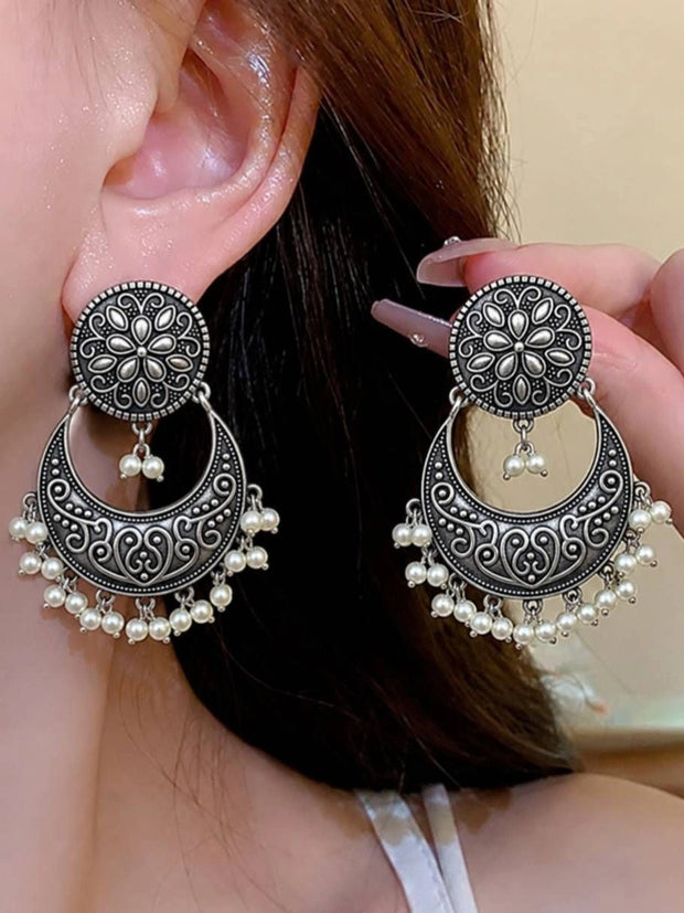 Oxidised silver chandbali earrings worn on a model ear showing full length and pearl drops
