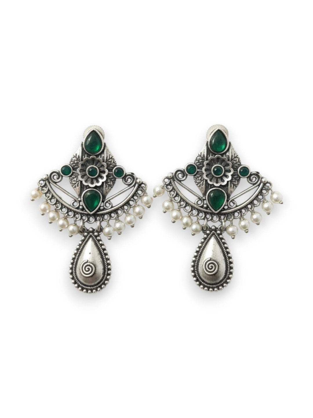 Pair of oxidised silver chandbali earrings with green stones and white pearl drops on white background