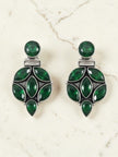 Pair of oxidised silver drop studs with emerald green marquise and round stones on marble surface