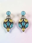 Front view of blue and yellow stone oxidised silver drop earrings on a light gradient background