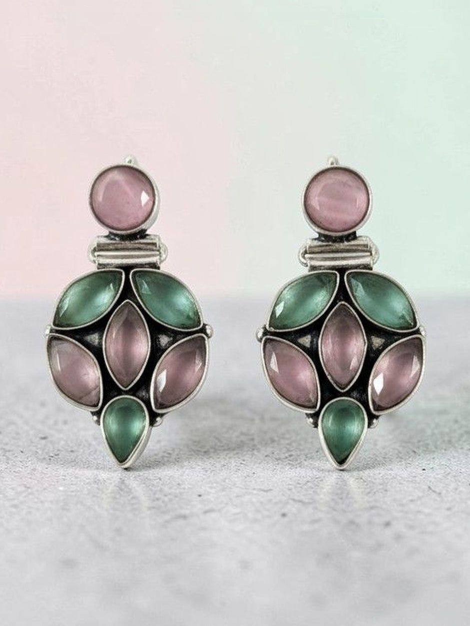 Oxidised silver pink green stone drop earrings displayed on grey surface with soft pink and mint background