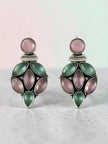 Oxidised silver pink green stone drop earrings displayed on grey surface with soft pink and mint background