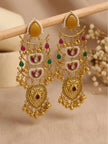 Pair of gold-plated kundan chandbali earrings hung on a wooden rod showing full layered detail