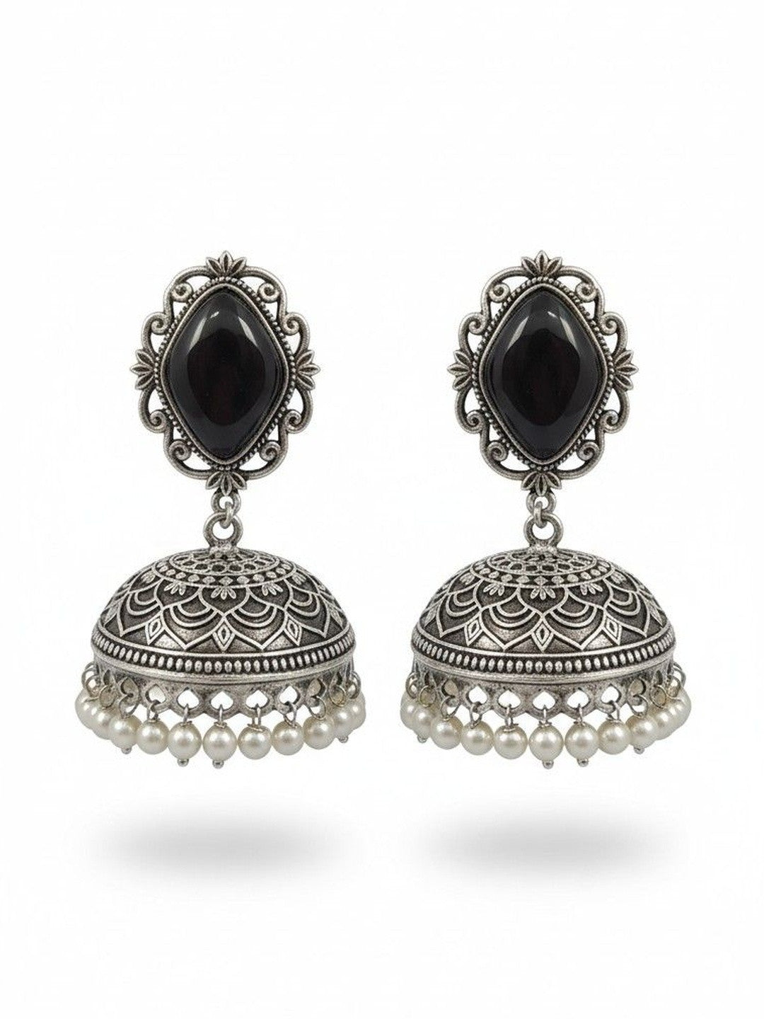 Pair of oxidised silver jhumka earrings with black stone tops and ivory pearl drops on white background