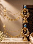 Pair of gold-plated chandbali jhumka earrings with blue stone tops and ghungroo hair chains displayed on a carved wooden block