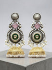 Front-facing oxidised silver peacock jhumka earrings with green kundan centre and pearl bead fringe on grey surface