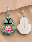 Front and back view of meenakari hook earrings showing painted lotus face and plain silver metal reverse