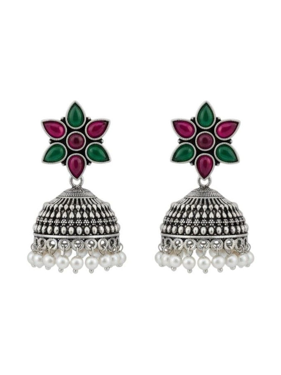 Full view of oxidised silver jhumka earring pair with engraved dome bell and white pearl drops on white background