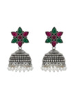 Full view of oxidised silver jhumka earring pair with engraved dome bell and white pearl drops on white background