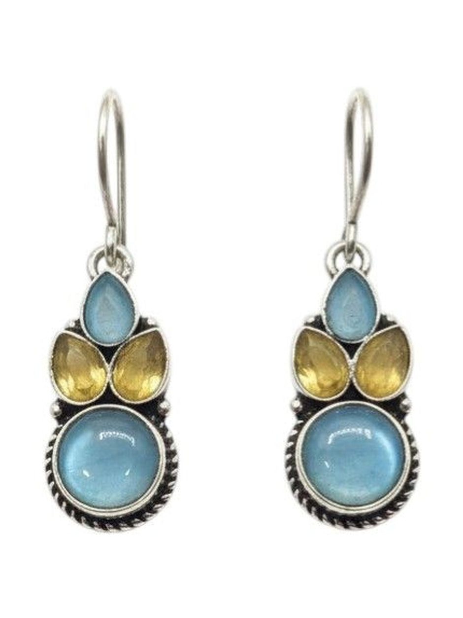 Front view of oxidised silver drop earrings with blue cabochon base and yellow faceted teardrop accent stones on white background