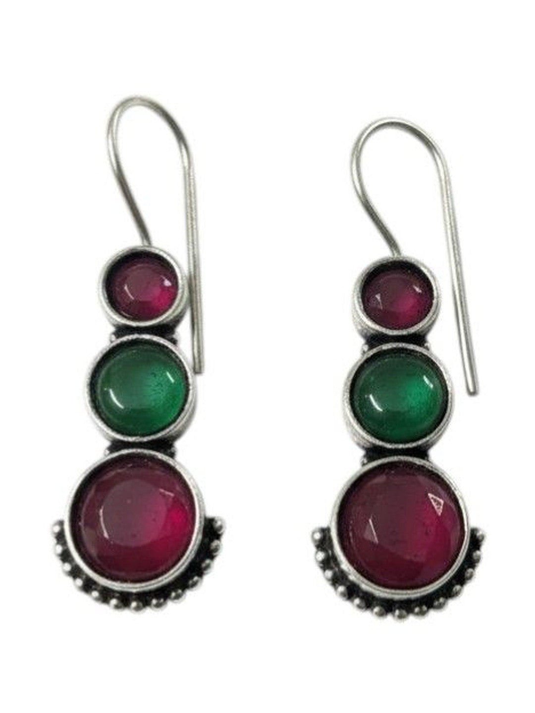 Front view of oxidised silver graduating stone drop earrings showing ruby-pink and green cabochons on white background