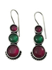 Front view of oxidised silver graduating stone drop earrings showing ruby-pink and green cabochons on white background