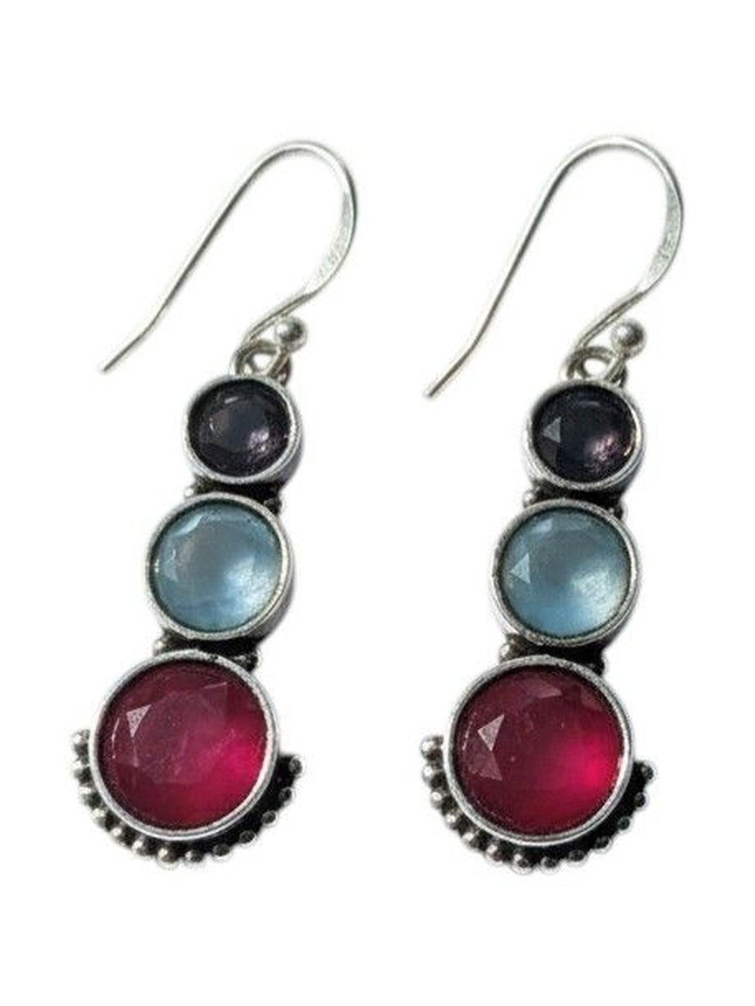 Close-up of silver drop earrings with three graduated coloured stones and dotted beadwork detail on white background