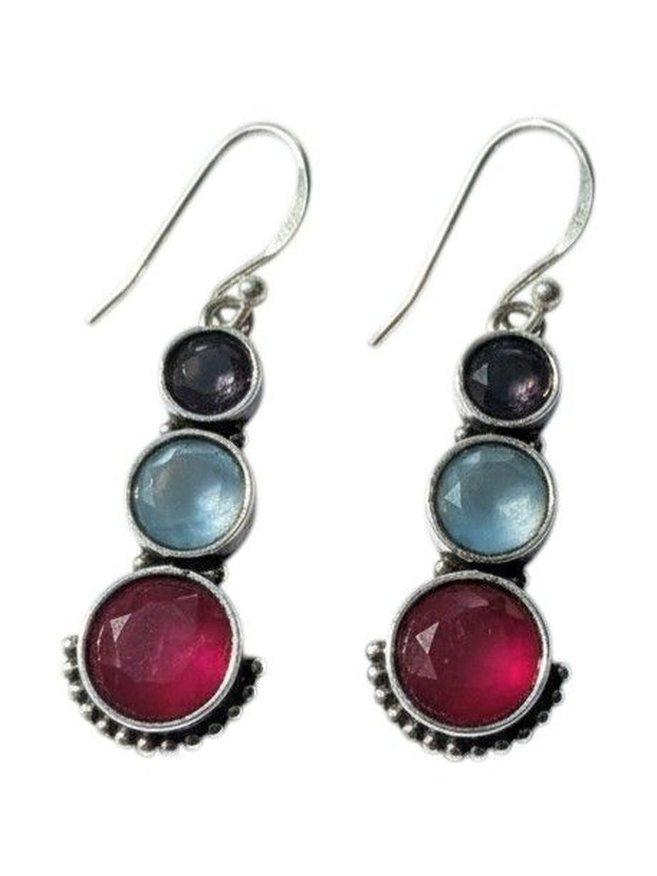 Close-up of silver drop earrings with three graduated coloured stones and dotted beadwork detail on white background