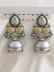 Pair of oxidised silver dual-tone jhumka earrings displayed on a white earring stand showing front detail
