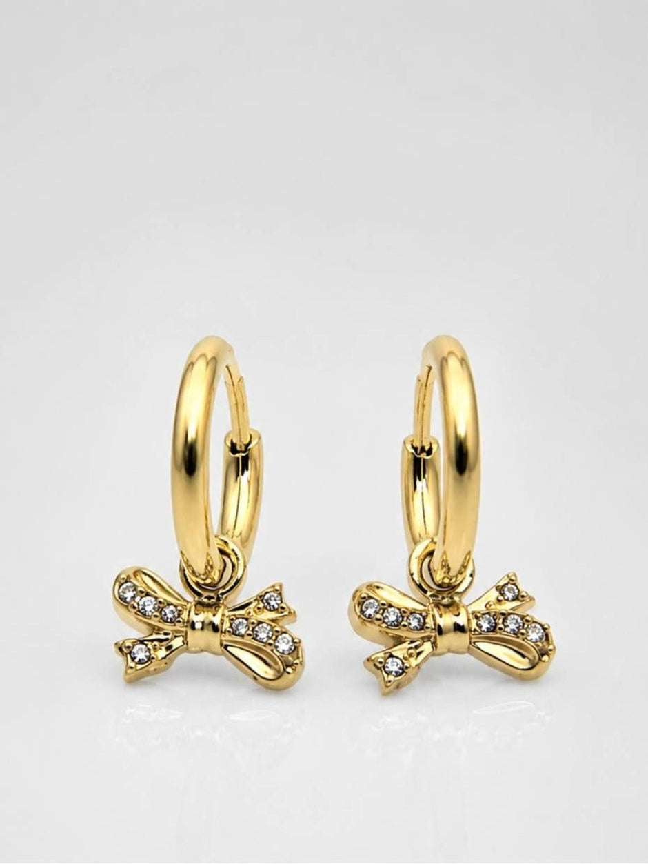 Two gold-plated bow charm hoop earrings displayed on white surface showing front and back angle