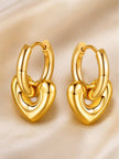 Close-up of chunky gold-plated puffy heart pendant hoops on cream satin background