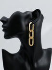 Gold-toned three-link oval chain drop earring displayed on a black jewellery bust, side profile view