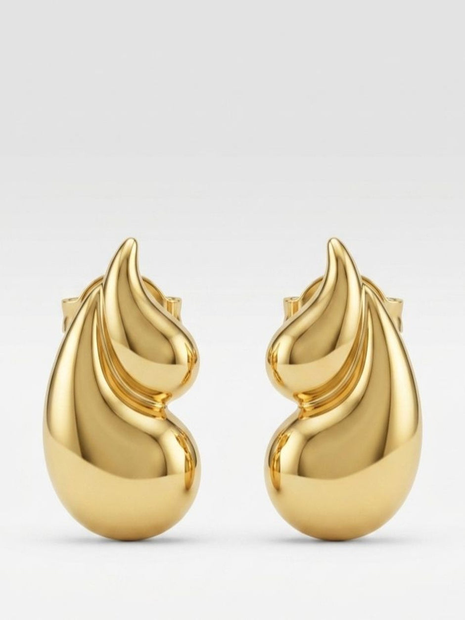 Front-facing product shot of gold-toned flame drop stud earrings on a clean white-grey background