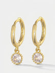 Pair of gold-plated S925 hoop earrings with round crystal solitaire charm pendants on white background