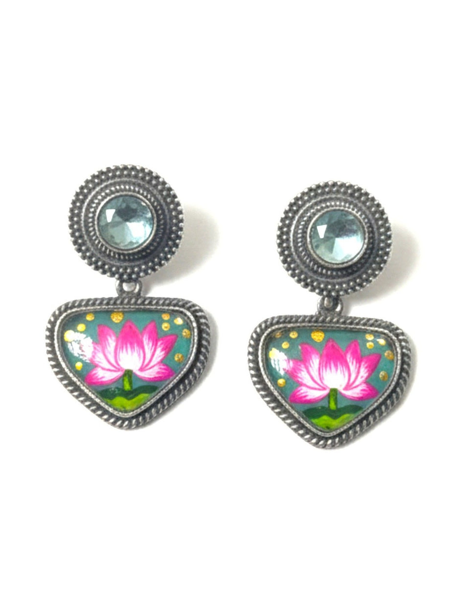 Pair of oxidised silver drop earrings with hand-painted teal and pink lotus enamel pendants on white background