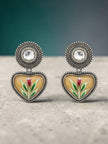Oxidised silver enamel heart stud earring worn on a woman's ear showing fit and scale