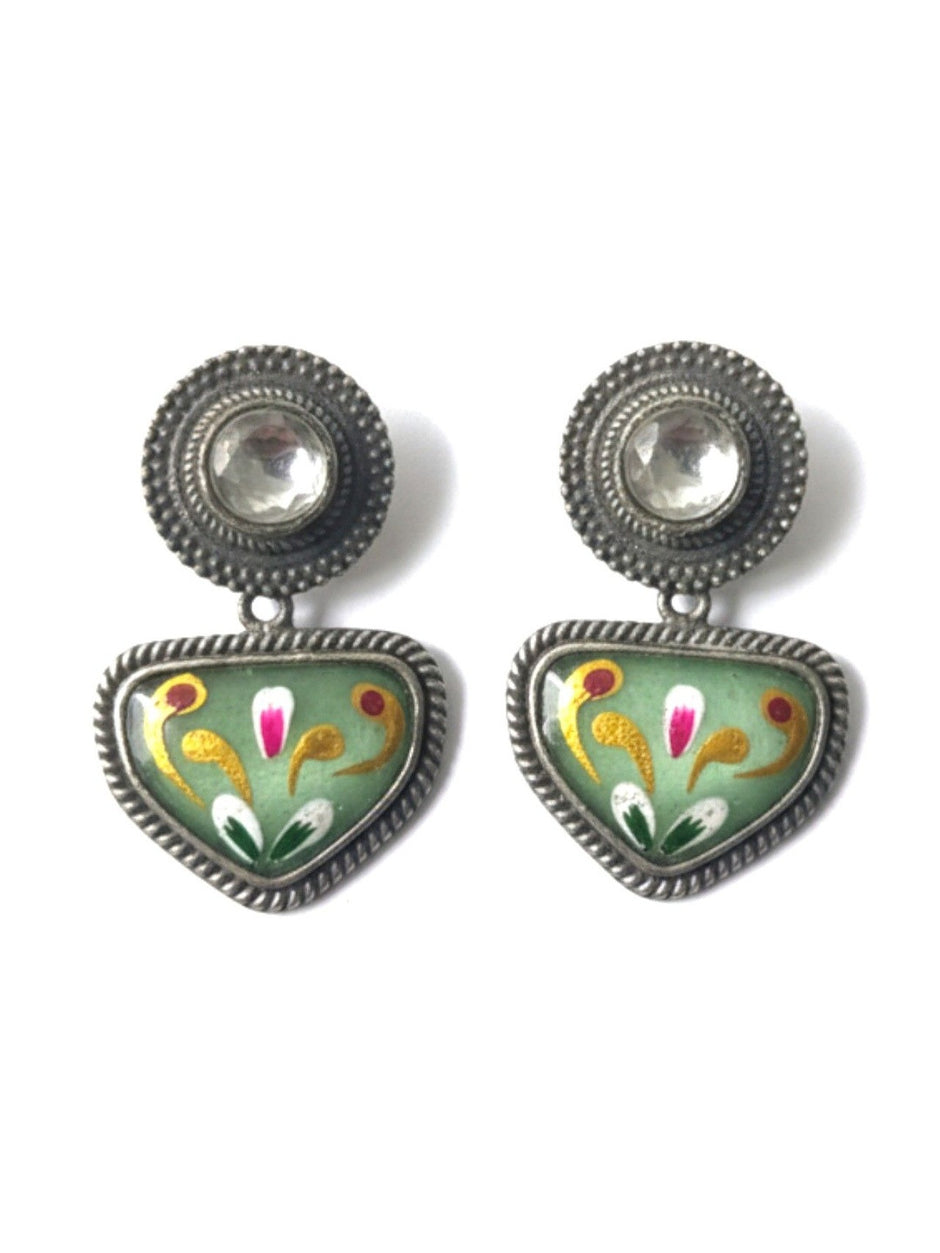 Front view of both oxidised silver meenakari kundan stud earrings on white background showing floral bird motifs