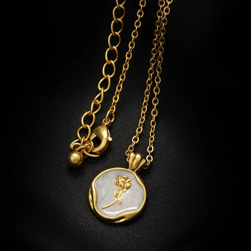 Luxury gold plated pendant necklace with white enamel round locket featuring embossed rose flower design on black background, elegant women's jewelry
