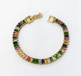 Gold tennis bracelet with multicolored baguette-cut cubic zirconia stones.