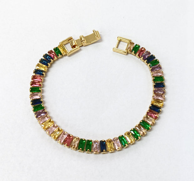 Gold tennis bracelet with multicolored baguette-cut cubic zirconia stones.
