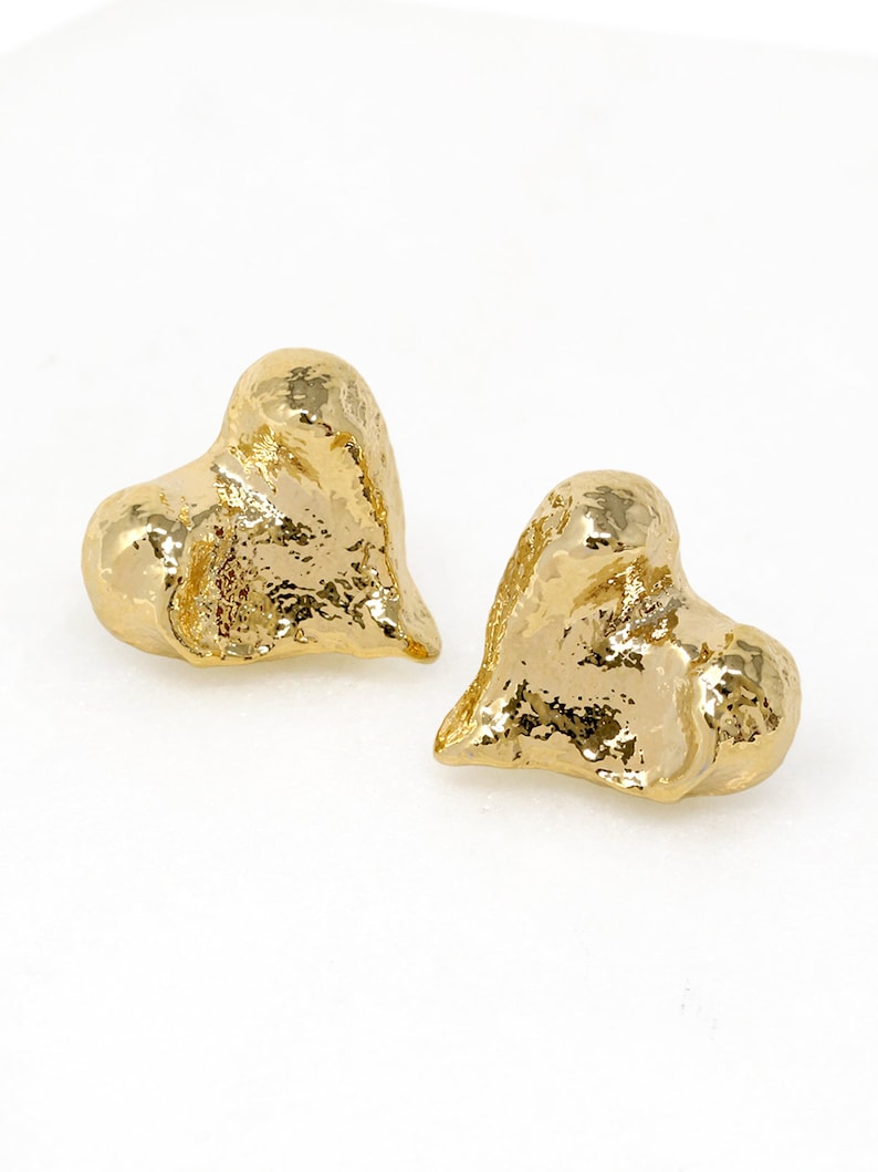 Gold textured heart stud earrings on white background, elegant romantic jewellery for casual and dressy looks