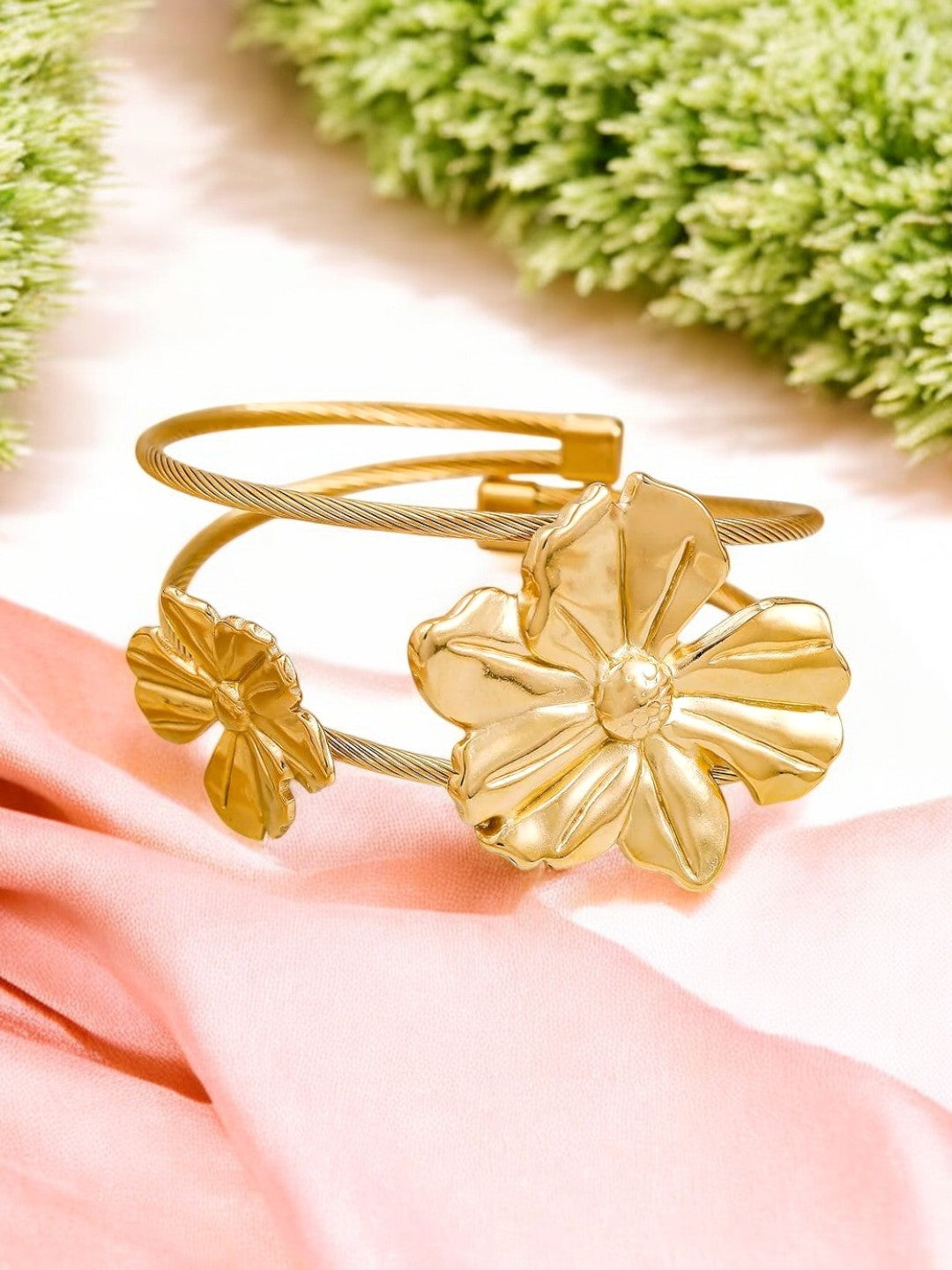 Elegant gold plated floral cuff bracelet with statement flower design, perfect for adding a touch of charm to party and festive looks.